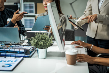 Asian colleagues meet at a desk, discussing business financial terms, investment strategies,...