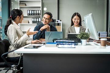 Asian colleagues meet at a desk, discussing business financial terms, investment strategies,...