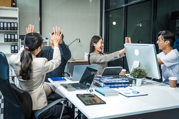 Asian colleagues meet at a desk, discussing business financial terms, investment strategies,...