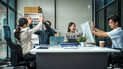 Asian colleagues meet at a desk, discussing business financial terms, investment strategies,...