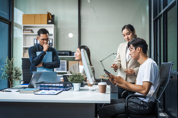 Asian colleagues meet at a desk, discussing business financial terms, investment strategies,...