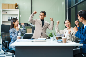 In a boardroom, an Asian team meets at a desk, presenting financial terms and strategies. Executives and employees collaborate, sharing ideas and work guidelines for success during an annual meeting.