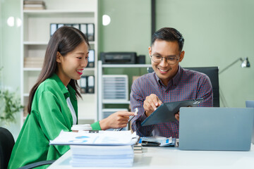 In a boardroom, an Asian team discusses startup financials and business terms. They present...