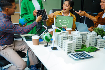 Colleagues in formal suits meet at desk to brainstorm environmental management strategies. discuss carbon emissions, renewable energy, sustainable business practices to reduce corporate footprint.