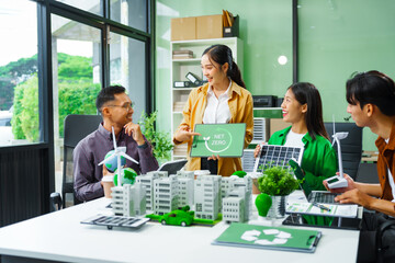 Colleagues in formal suits meet at desk to brainstorm environmental management strategies. discuss...