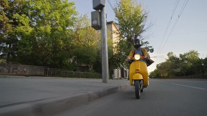 Courier man carry package moped. Guy ride yellow retro scooter city street deliver box in backpack. Fast food delivery service. Person drive bike with store bag. Express home order. Rush rider hurry.