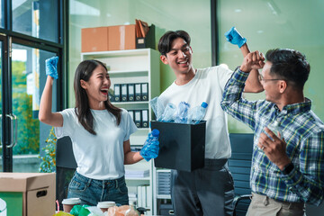 In an office, an Asian team discusses waste management strategies at a desk, separating plastic...