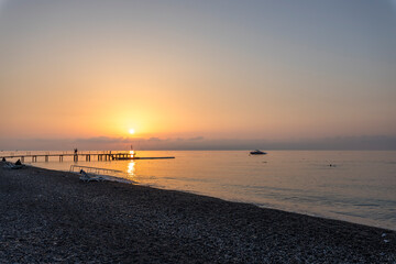 A beautiful sunset over the ocean with a boat in the water