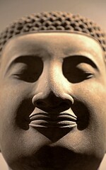 Smiling Buddha face. Detail of the Buddha statue