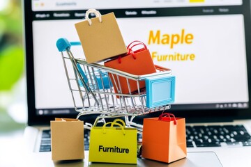 Miniature Shopping Cart with Colorful Boxes on Laptop Displaying "Maple Furniture" Website, Highlighting E-Commerce Technology and Luxury Branding