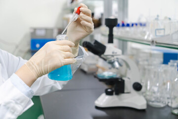 Researchers observe experimental samples in glass containers in the laboratory