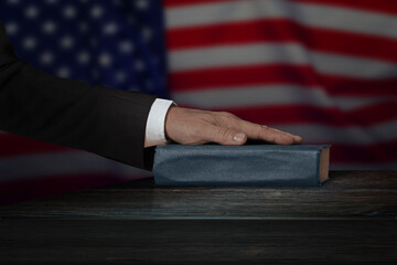 Hand on the Bible in court or the oath on the constitution book during the inauguration in...