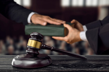 Hand on the Bible in court or the oath on the constitution book. The witness is sworn in