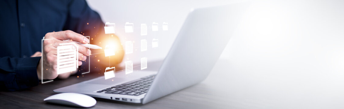 Businesswoman working on laptop with virtual screen. Online documentation database, IT consultant being set up Virtual Document Management System with a laptop, Software for archiving corporate files.