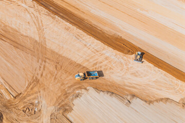 Aerial shot of earthmoving at construction site © AlexGo