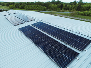Large roof with solar panels in rural green landscape