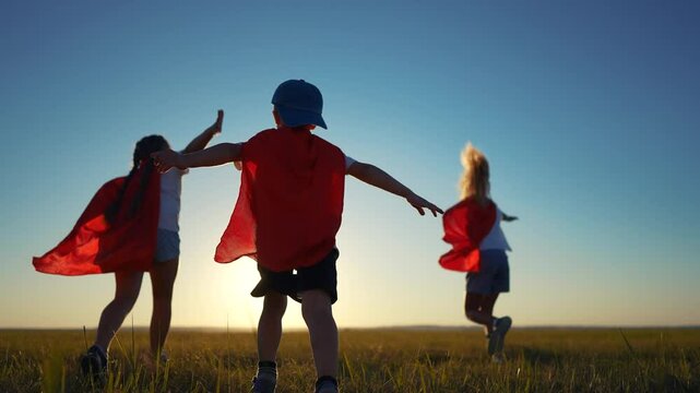 A group of kids are running around with superheroes. Hero super child concept. Group of children running together, lifestyle silhouette of. superheroes. A group of kids run together like superheroes.