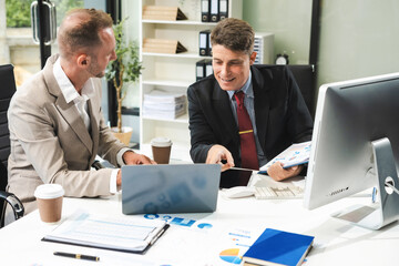 Fototapeta premium Male mature caucasian ceo with diverse coworkers team, executive managers group at meeting. professional businesspeople working together.