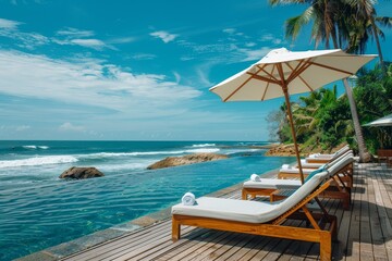 Obraz premium Indian Beach Resort with Outdoor Swimming Pool, White Umbrella, Wooden Sunbeds Near Ocean on Sunny Day, Sri Lanka Hotel View.