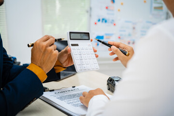 close-up of a car salesman handing the keys to an Asian customer after signing an insurance agreement. business transaction, ownership and customer service in the automotive industry.