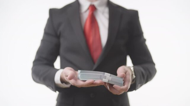 Headless businessman in suit flipping through a pack of money 4K