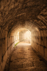 Turkey, stone and tunnel in ruins for architecture, archeology and travel to ancient city. History, rock and path in abandoned Greek theater for exploration, culture and anthropology in Greece