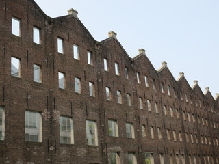 row of facades in brick stones with empty window sills