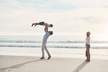 Mom, dad and child on beach lift for playing on holiday, vacation and weekend together. Family,...