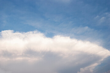 dramatic clouds in blue sky