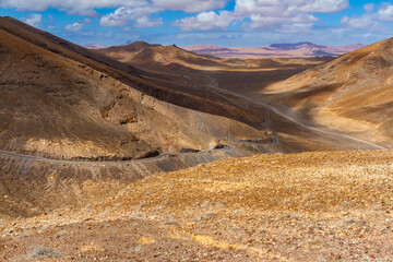 A narrow , winding road in the mountains. Road to the lighthouse.  East coast of Fuerteventura. Canary Islands, Spain