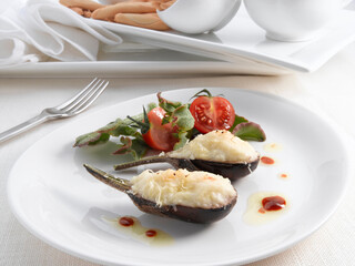 Berenjenas rellenas de verduras con bechamel y ensalada. Eggplants stuffed with vegetables with bechamel and salad.