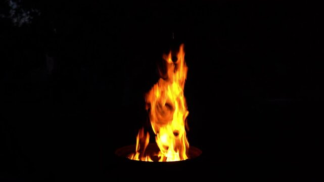 A burning fire in the barbecue at night in the country