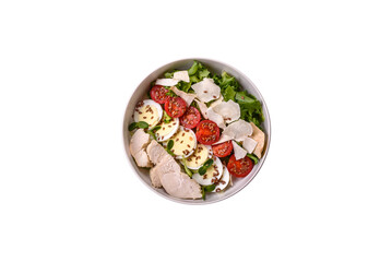 Delicious fresh caesar salad in a bowl with chicken breast, egg, tomatoes