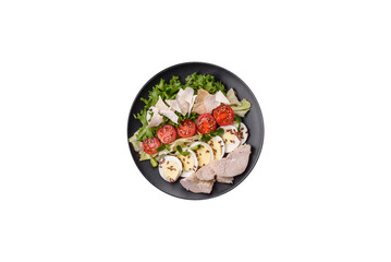 Delicious fresh caesar salad in a bowl with chicken breast, egg, tomatoes