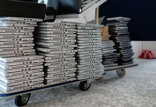 Stack of laptops in the storage room of a company