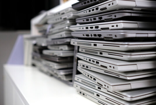 Stack of laptops in the storage room of a company