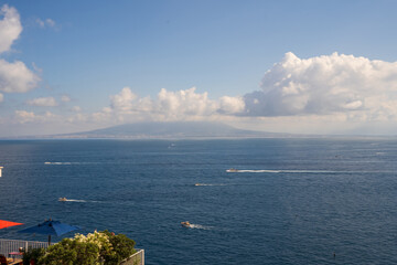 View of Sorrento and lots of boats and ship sailing showcasing Mount Vesuvius in the Background