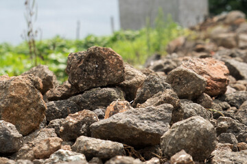 A significant heap of rocks is positioned adjacent to the road, contributing to the rugged terrain of the area