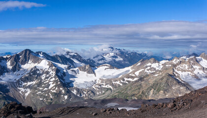 panoramic high mountainous landscape of Caucasus, peaks and glaciers among clouds