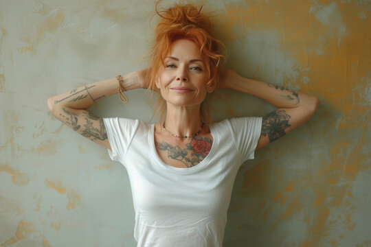 Confident tattooed woman smiling in casual white top indoors