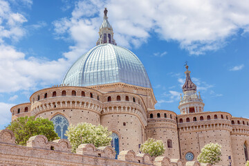 The stunning architecture of the Basilica of the Holy House in Loreto under a vibrant blue sky....