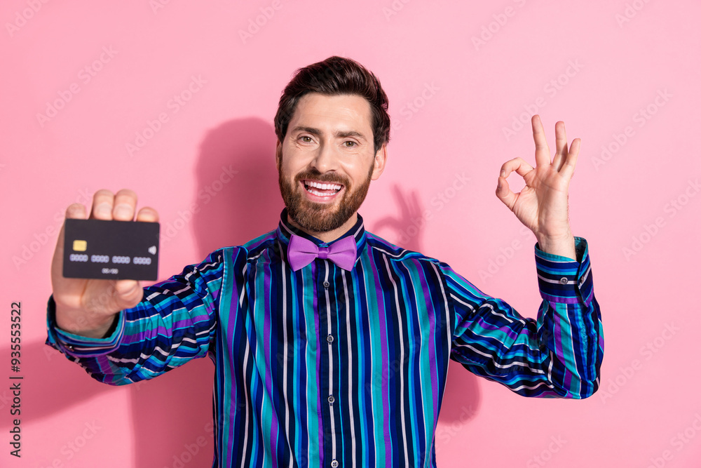 Poster photo of attractive cheerful elegant man guy wear trendy clothes hold bank card thumb up isolated on