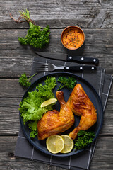fried chicken legs with lettuce, lemon on plate