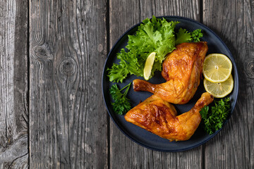 fried chicken legs with lettuce, lemon on plate