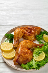 fried chicken legs with lettuce, lemon on plate