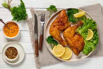 fried chicken legs with lettuce, lemon on plate