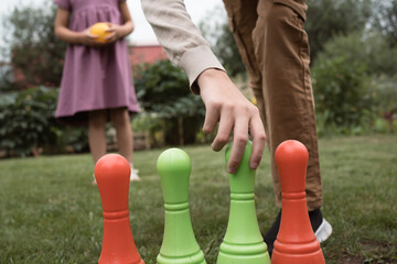 Fototapeta premium toy bowling with plastic skittles and ball outdoors in summer