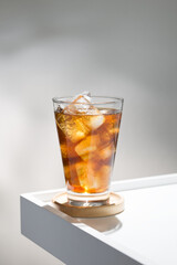 An iced americano in clear glass, simple elegance.