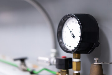 Pressure gauge, manometer, industrial pressure gas meter, blurred light background