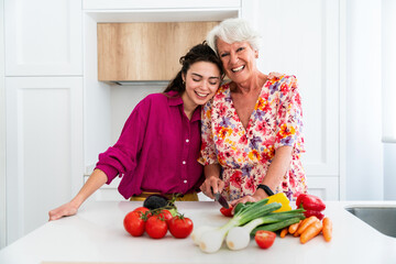 Beautiful grandmother and granddaughter together at home - Cheerful granma and nephew spending quality time together